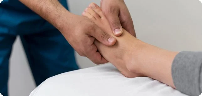 Podiatrist gently treating a patient’s foot