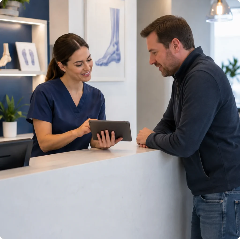 Front desk team member welcoming a patient at Achilles Foot Clinic